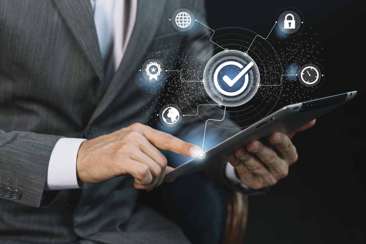 Business network technology displayed on tablet with security and global connection symbols