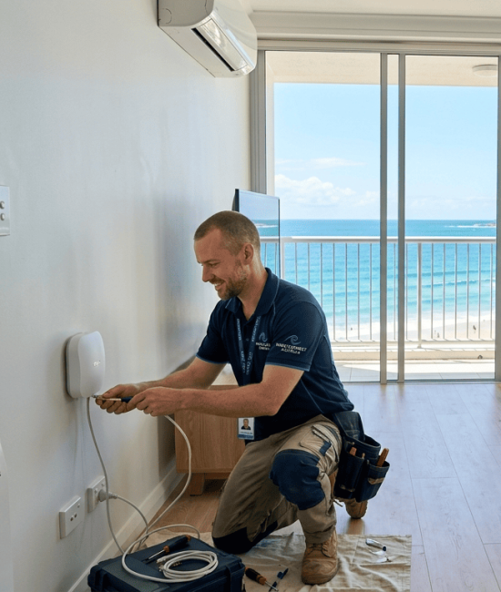 Wi-Fi installation technician setting up router in Mooloolaba apartment