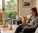 Frustrated Australian homeowner checking slow NBN speed on laptop
